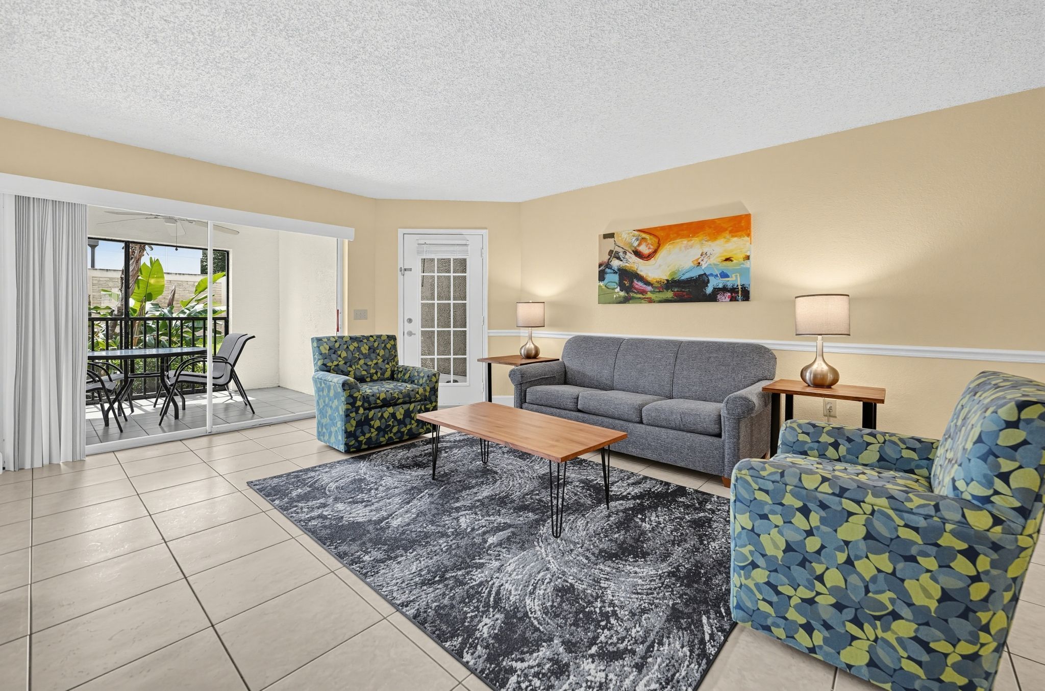 Living area with vibrant accent chairs and natural light