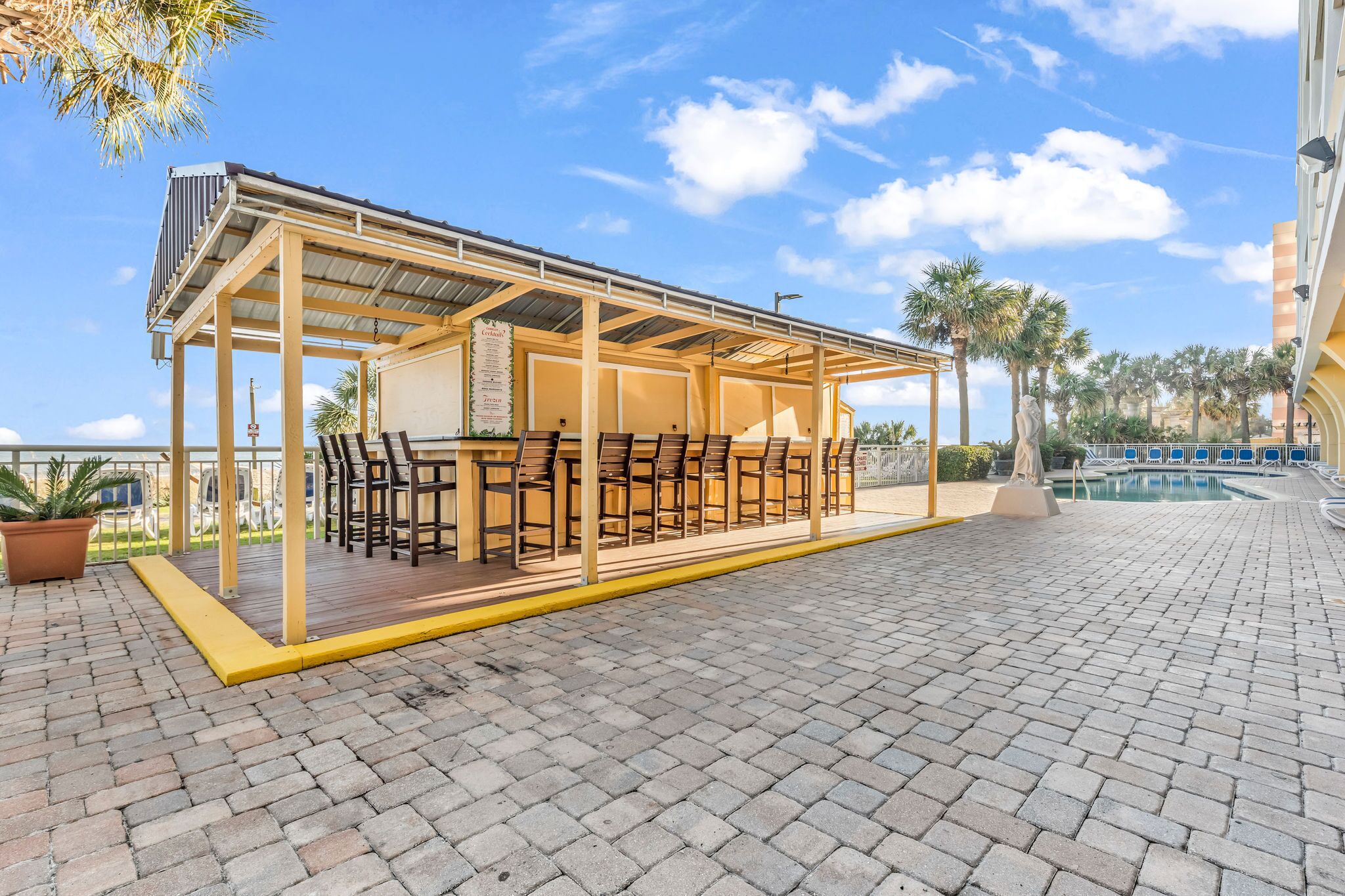 Outdoor bar with seating near pool area