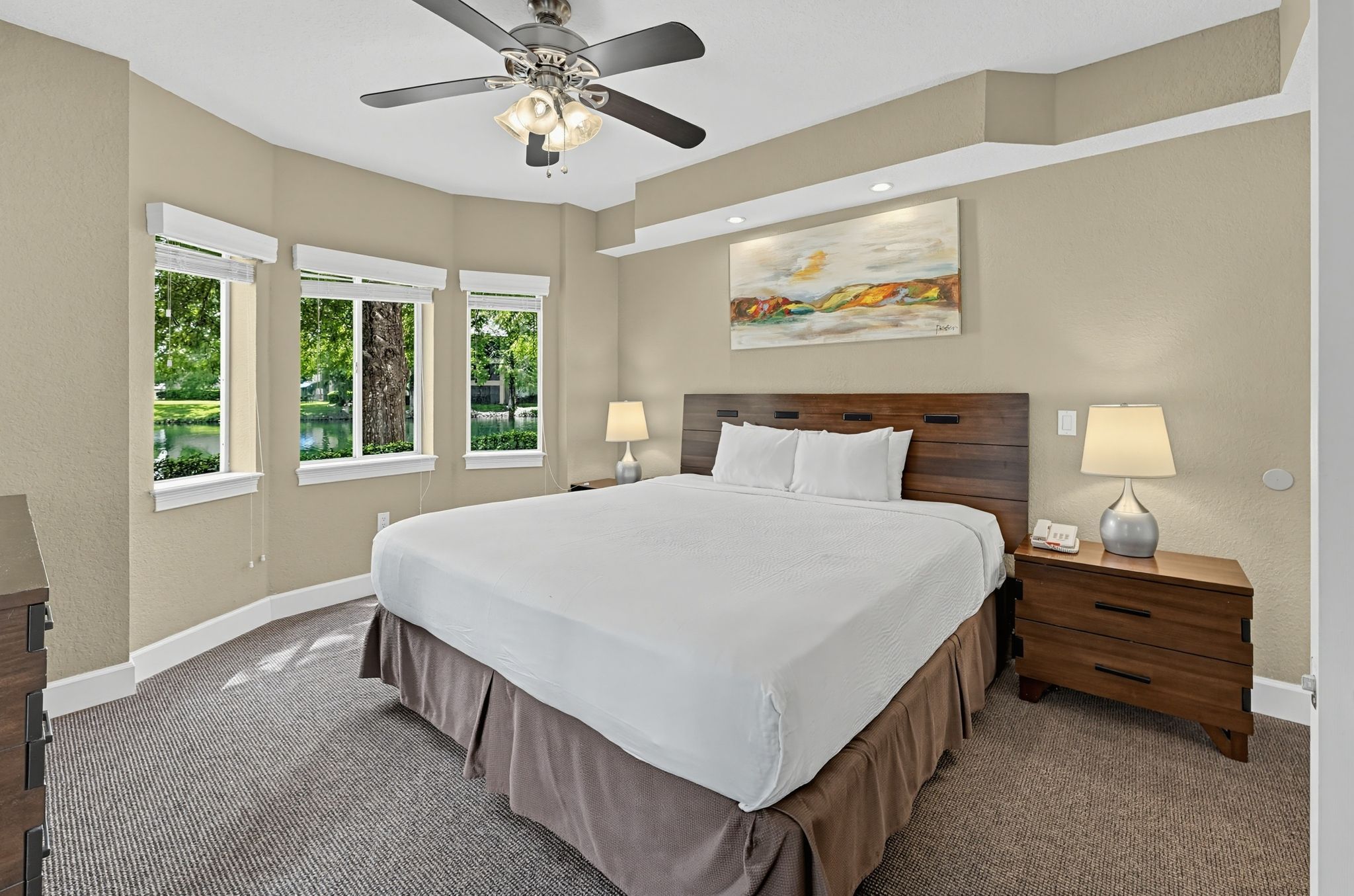 Enjoy the cozy ambiance of the bedroom, complete with a stylish lamp and plush bedding, ensuring a restful night after a day filled with adventure at nearby Disney World.