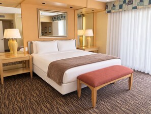 Bedroom with one bed, a bench, lamps, and a mirror - Accessible 2BR Condo w/ Shared Pool (Palm Springs)