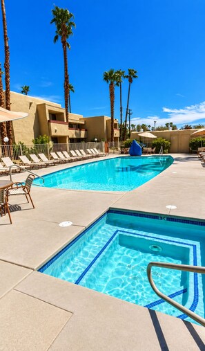 Outdoor pool with an adjacent hot tub and lounge chairs - Accessible 2BR Condo w/ Shared Pool (Palm Springs)