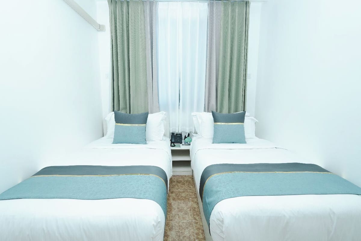 Twin Room (Garden Small Twin) | Minibar, in-room safe, blackout curtains, iron/ironing board