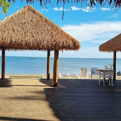 On the beach, black sand, sun-loungers, beach umbrellas