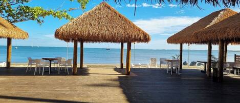 On the beach, black sand, sun-loungers, beach towels