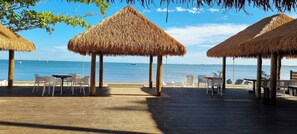 On the beach, black sand, sun-loungers, beach towels