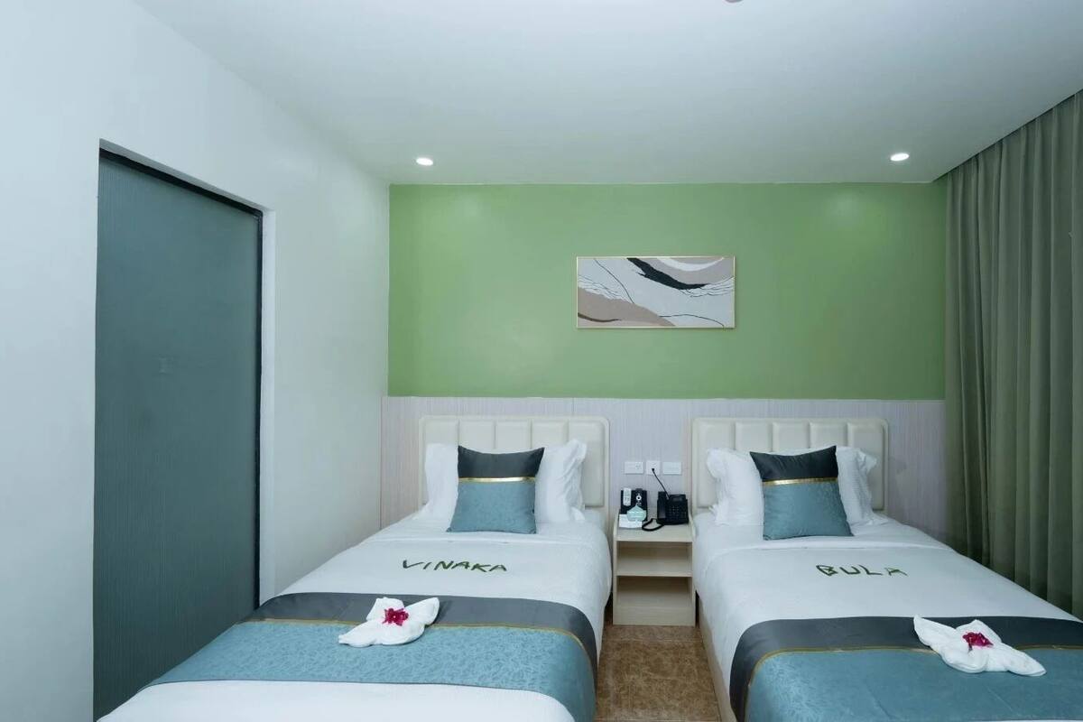 Twin Room, 2 Single Beds, Partial Ocean View (Garden) | Minibar, in-room safe, blackout curtains, iron/ironing board
