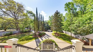 A residential driveway leading to a house with a white fence, a staircase, and a well-maintained lawn with trees and shrubs. - 5 Mi to Beach: Spacious Home on Hilton Head Island (Hilton Head Island)