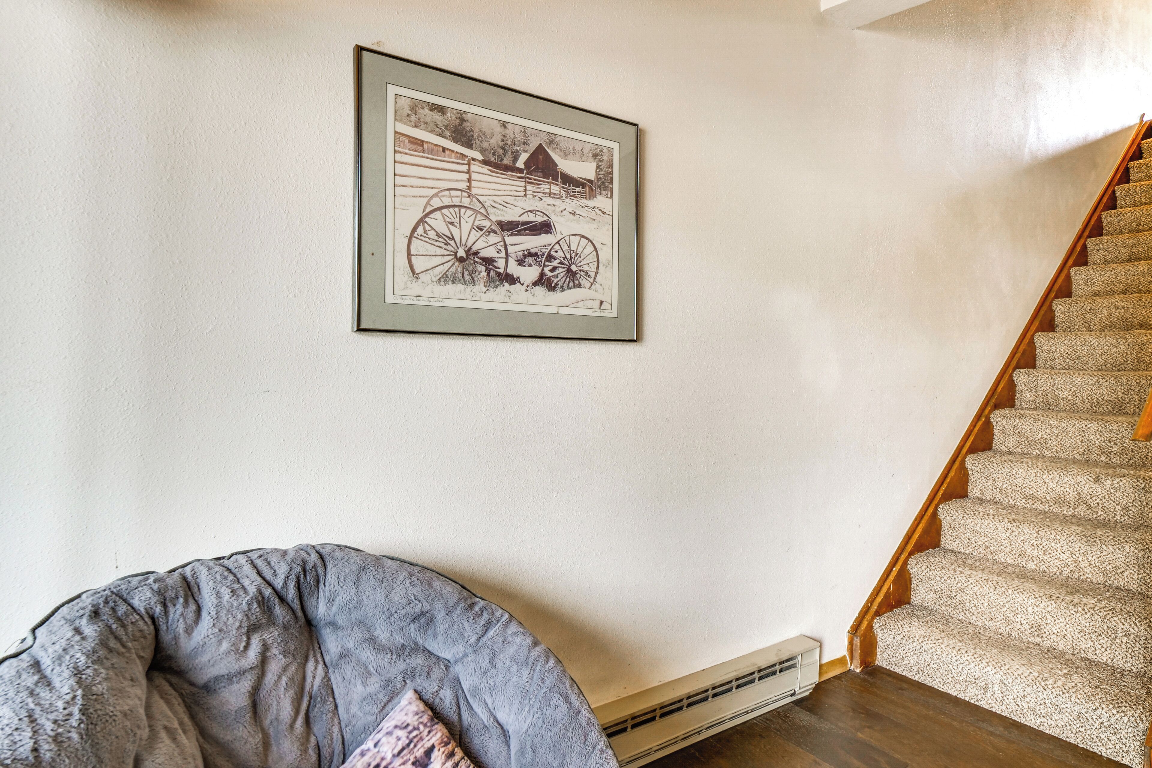 A staircase with wooden steps and a carpeted landing.