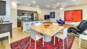 A modern kitchen with white cabinets, stainless steel appliances, and a central island. - 7 Mi to Flagler Beach: Breezy Stay w/ Pool Access! (Palm Coast)