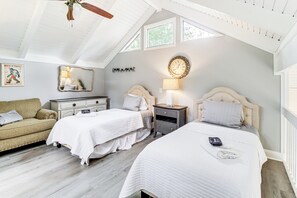 A bedroom with two beds, a sofa, a dresser, a mirror, and a clock on the wall. - Lake & Golf Course Views: Big Canoe Home w/ Deck! (Jasper)