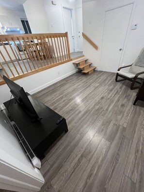 Relax in style with a dedicated entertainment area featuring a flat-screen TV and comfortable seating.