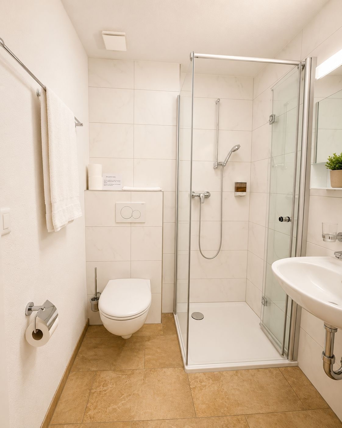 A modern bathroom with a glass-enclosed shower, a toilet, and a sink.