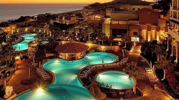 A resort with multiple swimming pools, a beach, and a mountainous backdrop. - Cabo San Lucas Luxury Executive Suite with Ocean View - sleeps up to 6.  (Cabo San Lucas)