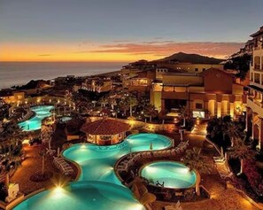 A resort with multiple swimming pools, a beach, and a mountainous backdrop. - Cabo San Lucas Luxury Executive Suite with Ocean View - sleeps up to 6.  (Cabo San Lucas)