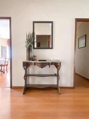 Cozy space with a console table, mirror, and comfortable chair.