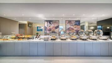 A buffet area with various food items and a modern design.