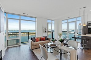 Design Apartment | Living area | 55-inch Smart TV with digital channels, Netflix, streaming services - The Pearl Waterfront Estate (Toronto)