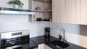 A modern kitchen with a built-in oven, a coffee maker, and a sink. - 3 bd in zona 2 (Ciudad de Guatemala)