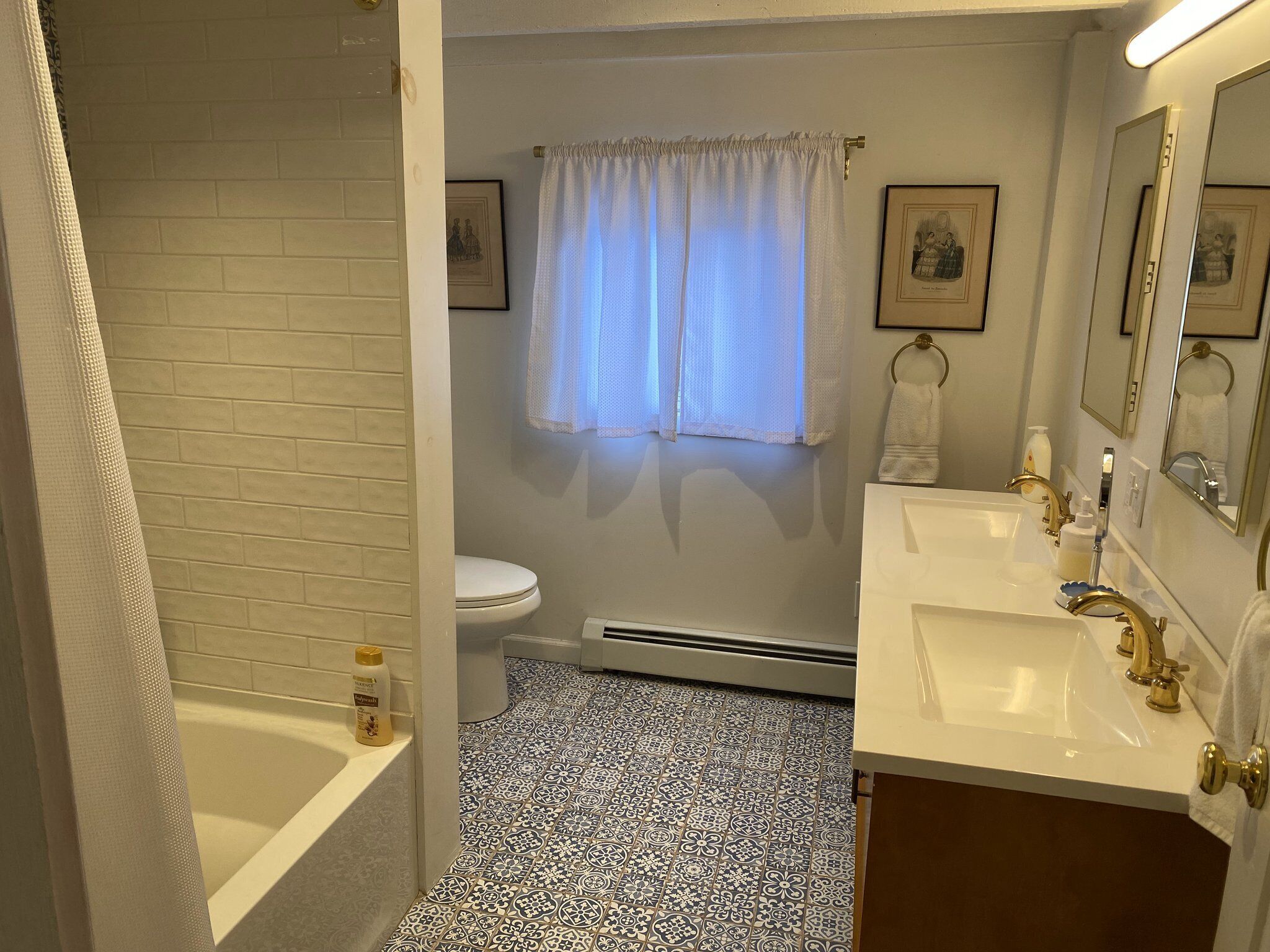 A bathroom with a bathtub, toilet, and sink.