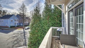 A residential balcony with a view of a street and neighboring houses. - Charming Uptown Charlotte Oasis with En Suites & Balcony with quiet street, walk to coffee shops nearby and minutes to convention center and uptown offices. (Charlotte)