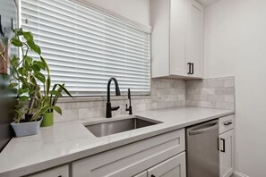 Dishwasher, coffee/tea maker, cookware/dishes/utensils, dining tables