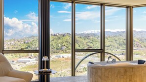A modern bathroom with a large window, a bathtub, and a Balenciaga-branded towel rack. - Rossi Luxury Hotel (Ardesen)