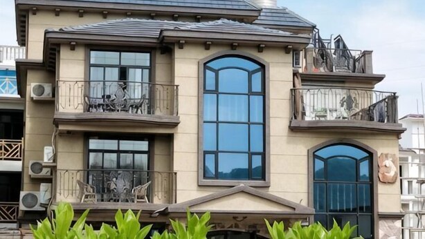 A two-story building with balconies, large windows, and a chimney. - Fallen Bay (Shengsi)