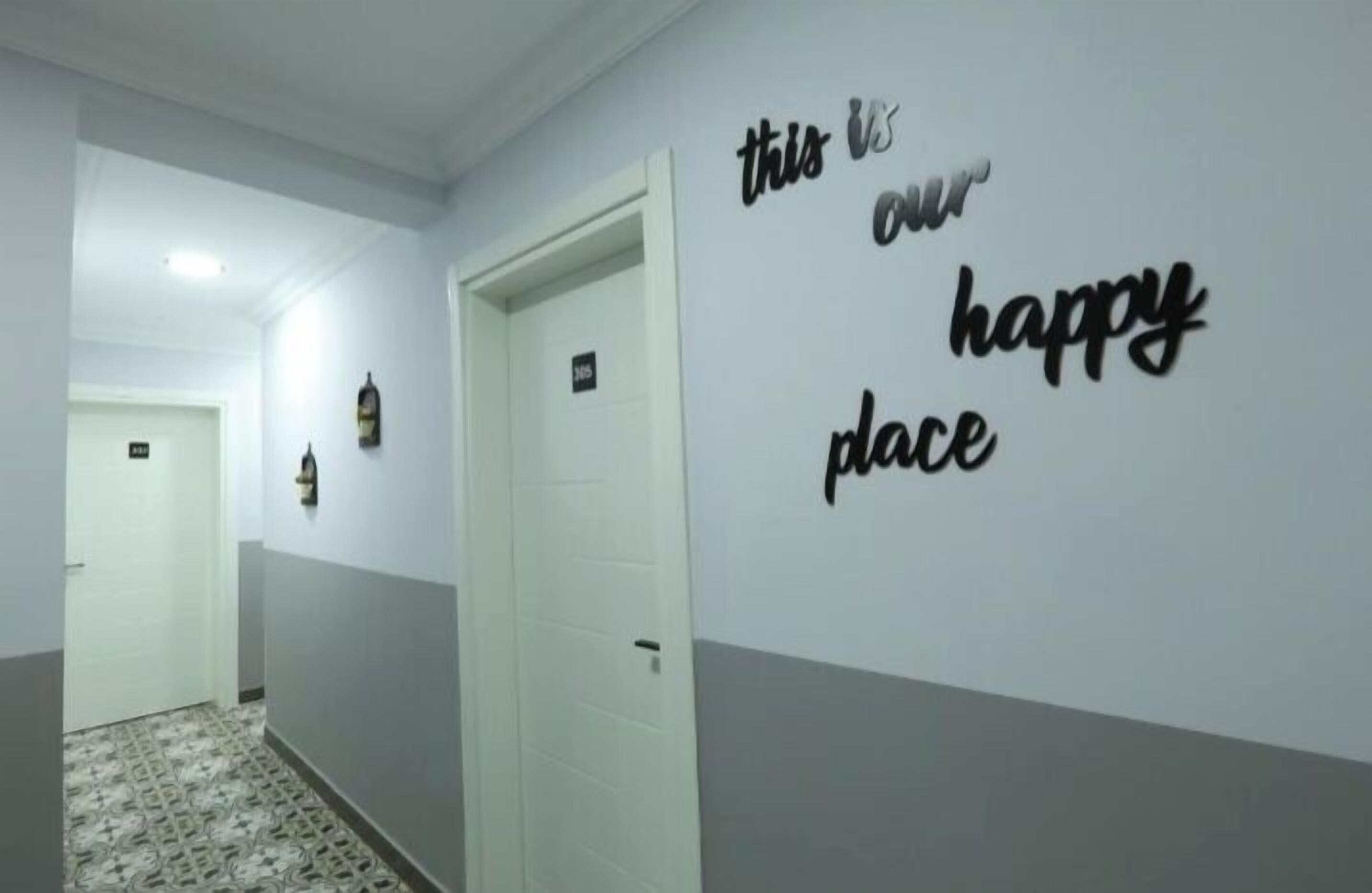 A hallway with a sign on the wall that reads "this is our happy place."