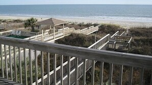 A beach view with a wooden deck and a gazebo. - Spacious Oceanfront Retreat -Steps to Sand & Pool Access! By Williamson Realty (Ocean Isle Beach)