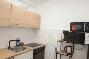 Microwave, stovetop, coffee/tea maker, cookware/dishes/utensils