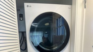 A stacked washer and dryer unit with a visible control panel and a hose connection. - *Clean *Modern Respite *WIFI *Private Yard (Prescott)