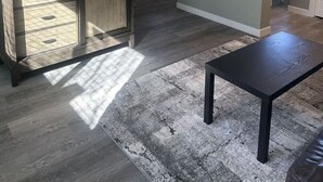 A modern living room with a flat-screen TV, wooden cabinet, and a black coffee table. - *Clean *Modern Respite *WIFI *Private Yard (Prescott)