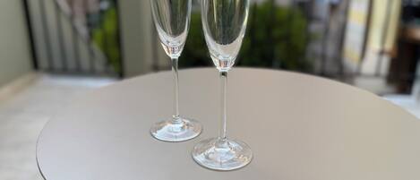 Two champagne flutes on a white table.