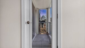 A narrow, enclosed balcony with a view of a bridge and construction site. - City Getaway, Free Parking, 24/7 Hour Gym (Cleveland)