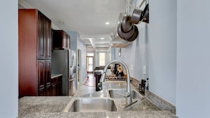 A kitchen with granite countertops, stainless steel appliances, and a modern faucet.