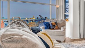A modern living room with a large window overlooking a construction site. - 2-bedroom apartment in brilliant Cleveland with WiFi, AC, fitness room (Cleveland)
