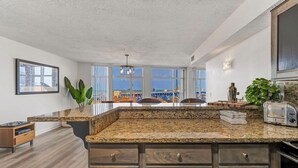 A kitchen with granite countertops, wooden cabinets, and a view of the ocean. - 2-bedroom apartment in brilliant Cleveland with WiFi, AC, fitness room (Cleveland)