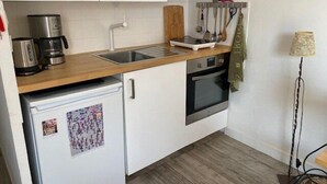 A compact kitchen with a sink, stove, and refrigerator. - CAP D'AGDE - Port Center // Ref 0142 (CAP D'AGDE)