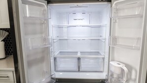 A Twin Cooling Plus refrigerator with multiple transparent storage drawers and a freezer compartment.