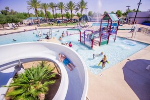 A water park with a large pool, slides, and a play structure. - Book for your winter getaway and enjoy sunshine in the Desert. (Tucson)