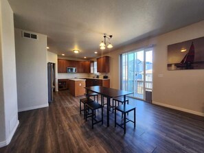 Enjoy cooking in this well-equipped kitchen with a central island, refrigerator, microwave, and sink.