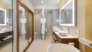 A modern bathroom with a large mirror, two sinks, a bathtub, and a shower. - Deluxe Ocean View Studio in Cabo, Villa la Valencia Resort (San José del Cabo)