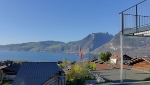 A residential area with houses, a flag, and a mountain in the background. - Huus Chloster, Apt Niesen by Interhome (Krattigen)
