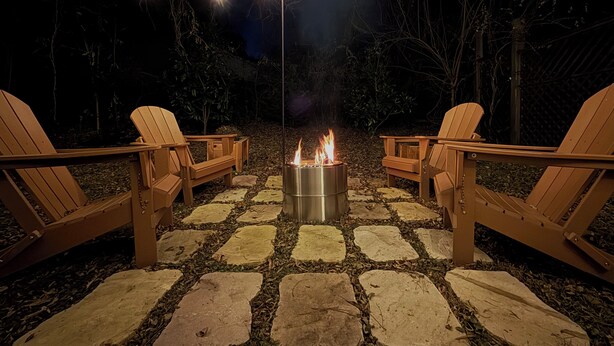 An outdoor seating area with Adirondack chairs and a fire pit. - Curated & Caffeinated! Gem near Duke & Downtown • Espresso bar, Eco+, Fire Pit (Durham)