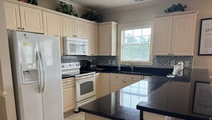 A kitchen with a refrigerator, stove, microwave, and sink. - Inviting 3-Bed Magnolia Pointe Condo Retreat | Magnolia Pointe Luster Leaf 4894-301 (Myrtle Beach)