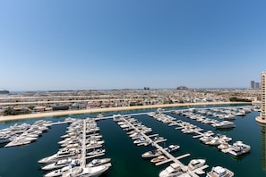 A marina with numerous boats docked in a clear, organized manner.