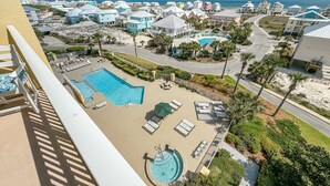 A resort with a swimming pool, sun loungers, and a view of the beach and ocean. - ESCAPE TO THE INDIES CONDO IN FORT MORGAN ALABAMA! (Gulf Shores)