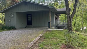 A small, single-story building with a sloped roof, a front door, and a small porch.