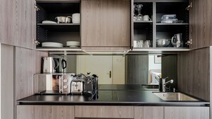 A modern kitchen with wooden cabinets, a stainless steel countertop, and a built-in oven.