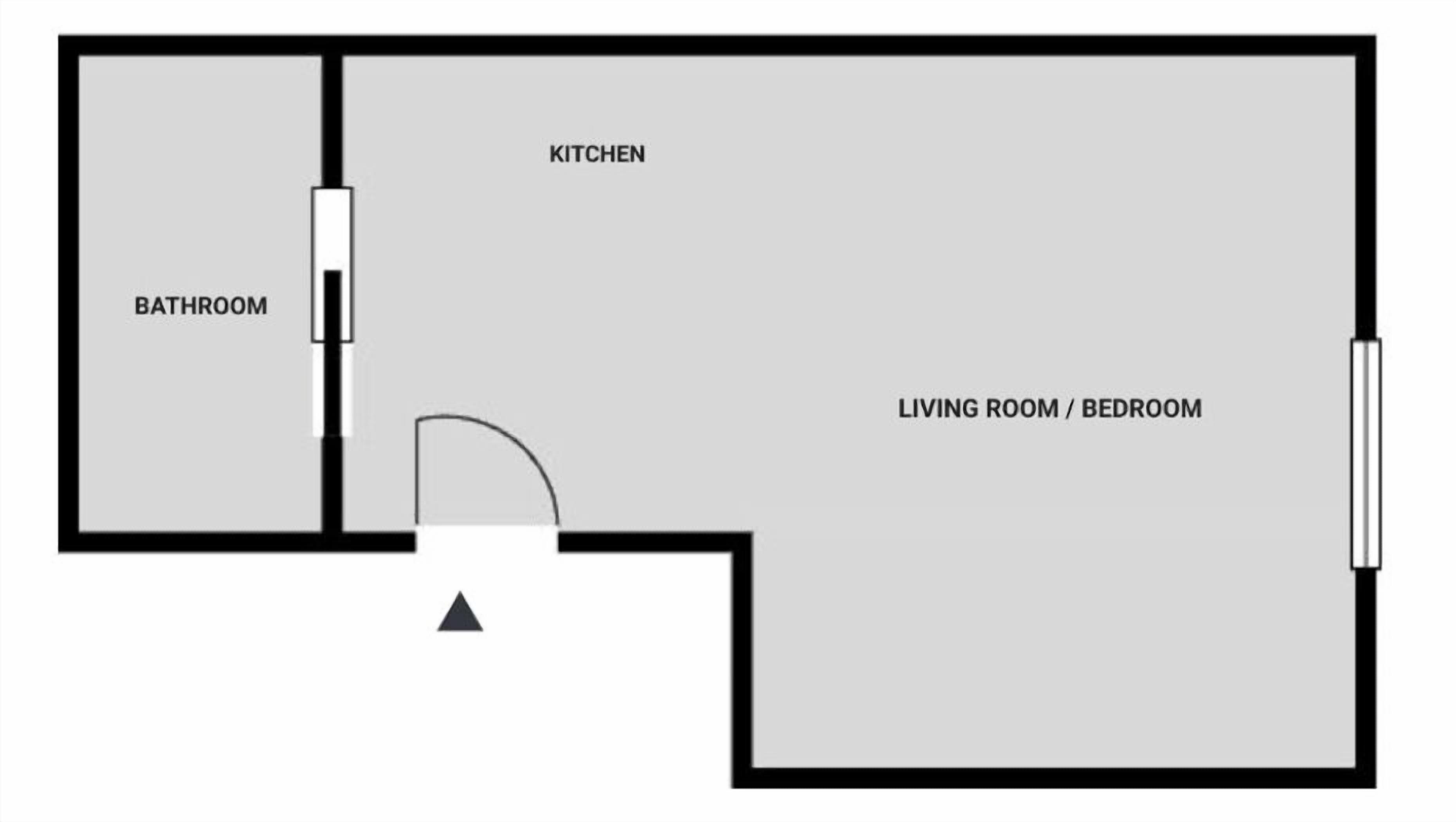 Een plattegrond met een keuken, badkamer en een woon-/slaapkamer.